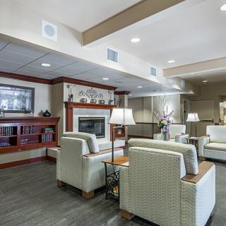 A cozy lounge area with comfortable seating and a fireplace.