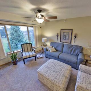 Cozy living room with comfortable seating and a scenic view through the window.