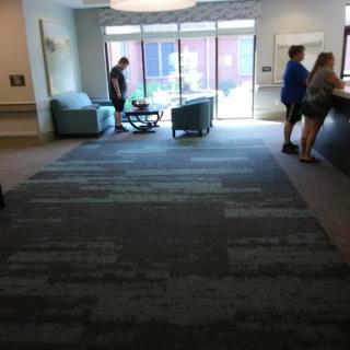 A spacious lobby with comfortable seating, bathed in natural light.