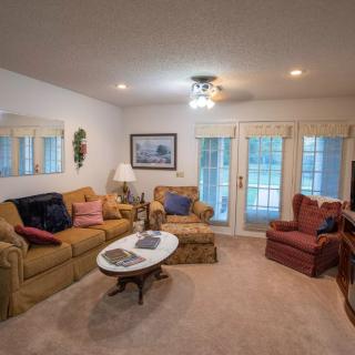 A cozy living room featuring comfortable seating and warm lighting.