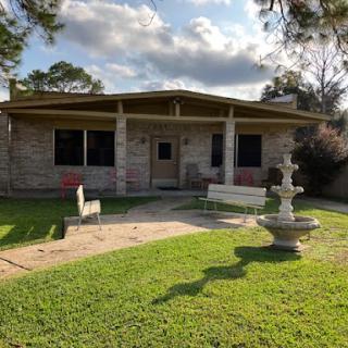 A charming house with a serene garden and a beautiful fountain.