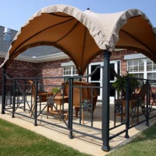 A cozy patio area with a stylish canopy providing shade over outdoor furniture.