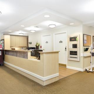 A modern and clean reception area with a desk and seating.