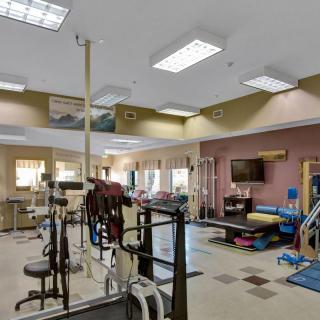 A spacious gym equipped with various exercise machines and fitness equipment.