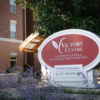 The Victory Centre building with its prominent sign for senior and assisted living services.