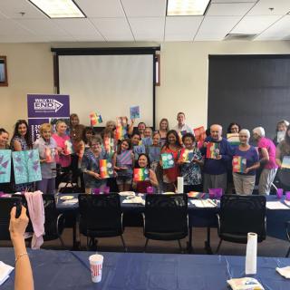 A group of people gathered in a conference room, posing for a photo during an event or meeting.