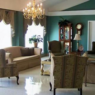 A traditional living room with elegant furnishings and a chandelier.