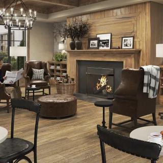 A cozy living room with a warm fireplace and comfortable seating.