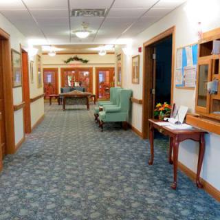 A well-lit hallway with comfortable seating and decorative elements.