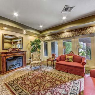 A cozy living room featuring a fireplace, comfortable seating, and elegant decor.