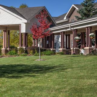 A suburban house with a well-maintained lawn and a front porch.