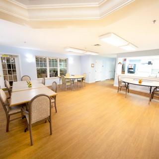 A spacious and well-lit dining area with multiple tables and chairs.
