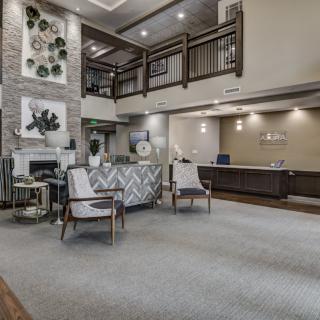 A modern lobby with seating area and a reception desk.