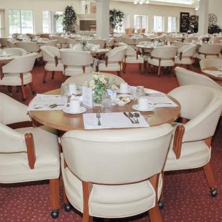 An elegant dining area with neatly arranged tables and comfortable seating.