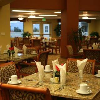 An elegant restaurant dining area with neatly set tables and warm lighting.