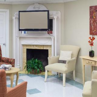 A cozy living room with a fireplace, television, and comfortable seating arrangements.