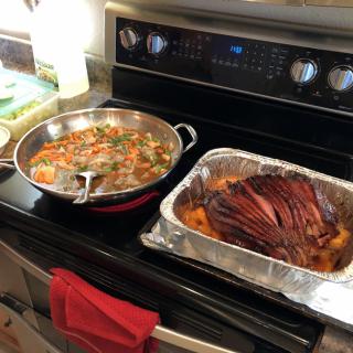 Freshly cooked ham and vegetables on the stove.