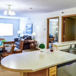 An open-concept kitchen and living area featuring a dining table and cozy seating.