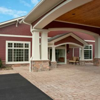 The building features a welcoming entrance with large windows and an awning.