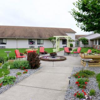 A well-maintained outdoor patio area with seating and landscaped gardens.