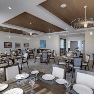 A modern dining room with neatly arranged tables and elegant decor.