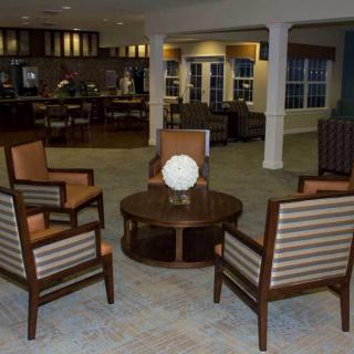 A cozy indoor seating area with four chairs surrounding a central table.