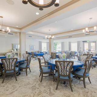 Elegant dining room with round tables and blue accents.