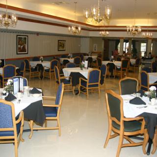 A spacious and elegantly arranged dining area with tables set for service.