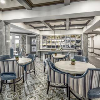 A modern restaurant interior featuring elegant seating and a stylish bar area.