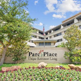 Front view of Parc Place, showcasing its unique retirement living facilities surrounded by greenery.
