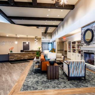 A modern and inviting lobby featuring stylish furniture and a cozy fireplace.