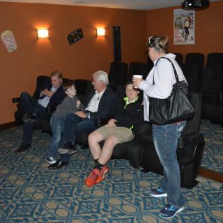 A group of people relaxing in a home theater setting.