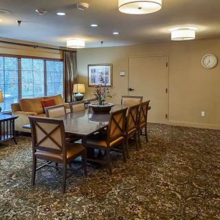 A cozy dining room with a large conference table and elegant decor.