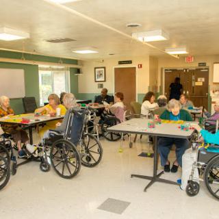 Residents engaging in activities in a nursing home setting.