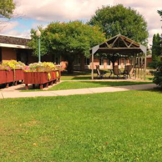 A serene outdoor space featuring a gazebo and well-maintained grass.