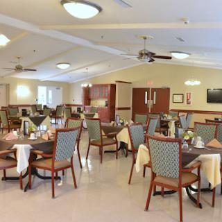 A spacious dining area featuring neatly arranged tables and chairs, creating a welcoming atmosphere.