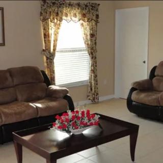 A cozy living room with brown sofas and a decorated coffee table.
