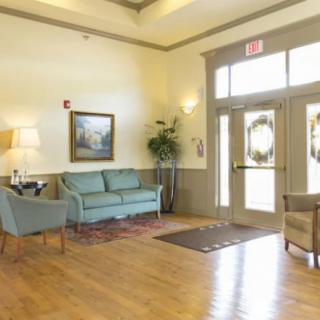 A bright and inviting lobby with comfortable seating and wooden flooring.