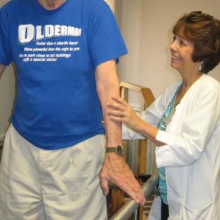 A therapist assisting a patient with physical therapy exercises.
