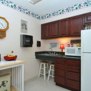 Cozy kitchen with wooden cabinets and modern appliances.