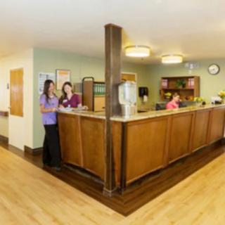 A reception area with staff at the front desk.