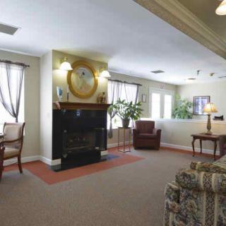 A cozy living room with a fireplace and comfortable seating.