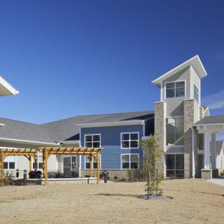 A modern residential building with a blue sky backdrop.