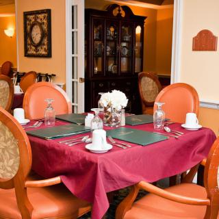 A cozy and elegant dining room with a neatly set table in a restaurant.