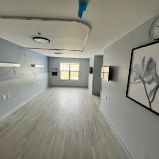 A modern, minimalist interior space with soft colors and decorative art.