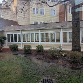 A view of a building's exterior with several windows and a landscaped area.