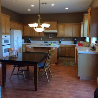 Spacious kitchen with wooden cabinets and a dining area.