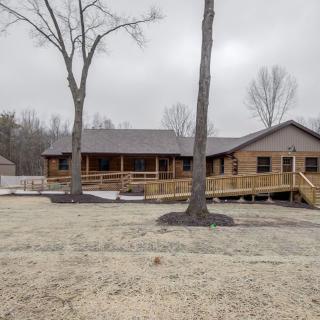 A wooden house with a ramp in a winter landscape.