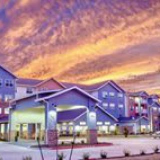A residential building complex under a vibrant sunset sky.