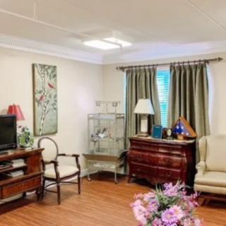 A cozy living room with elegant furniture and floral decorations.